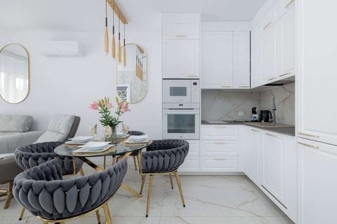 A compact kitchen with white cabinetry and modern appliances. The space is practical and designed for everyday cooking.