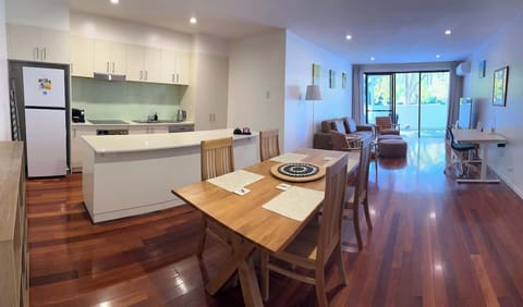 Adjoining the kitchen is a wooden dining table that normally accommodates four people but can be set for six or provide extra working space.