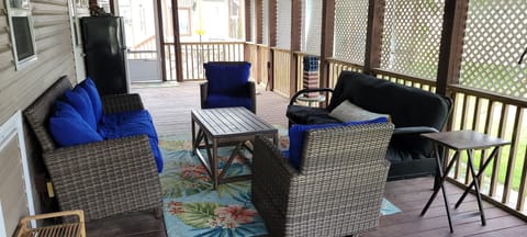 Porch with 65in TV and ample seating.