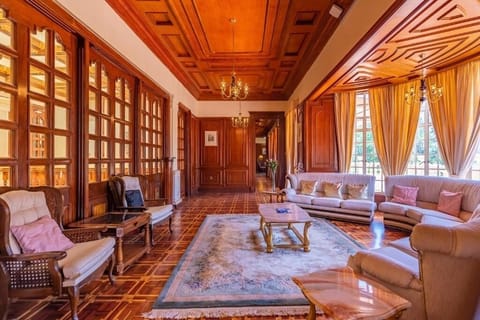 Gather on plush sofas in a sunlit hall of warm wood.