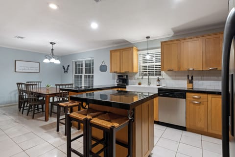 Kitchen and dining room. 3 seats on island , four chairs and a large bench.