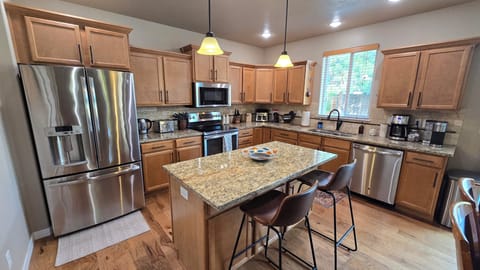 Fully stocked kitchen with many appliances and cooking supplies for every meal.
