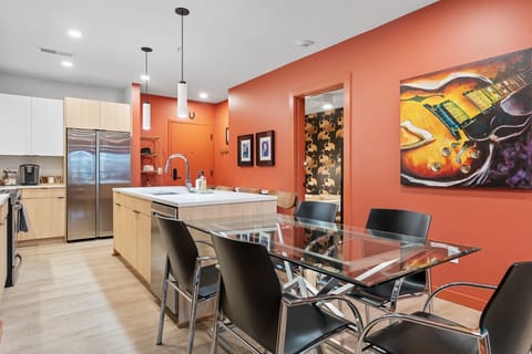 Gather friends and family around a stylish open kitchen designed for connection, comfort, and culinary creativity.