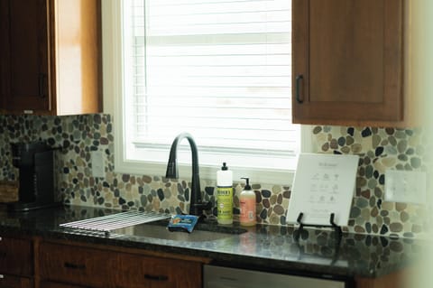 Kitchen sink with cleaning supplies and welcome binder
