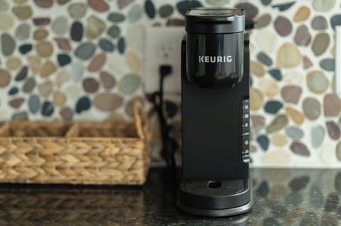 Keurig with pods, creamer packets, sugar and tea