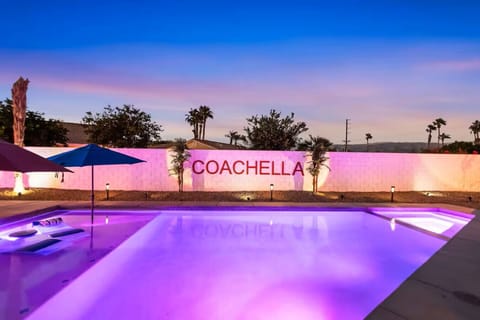 Twilight pool views w/ glowing lights & bold mural backdrop for memorable nights.