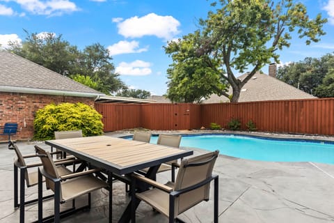 Picture-perfect days start here. This sunny backyard, with its private pool and outdoor seating, is the ultimate spot to unwind and enjoy the warm weather.