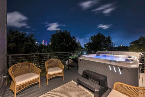 Private rooftop hot tub with cozy lounge seating perfect for relaxing under the stars after a long day.