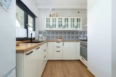 Another angle of the same kitchen, focusing on the sink and window above it.