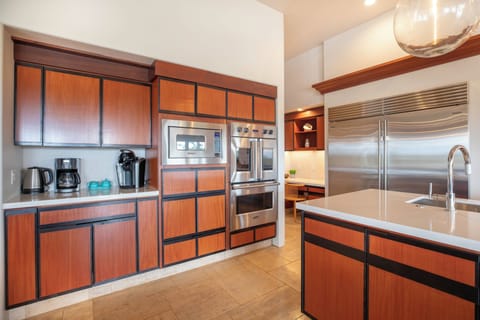 Your gourmet kitchen features sleek wood cabinetry and top-tier stainless steel appliances for effortless cooking during your stay.