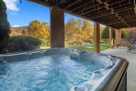 Relax in the private hot tub while soaking in beautiful valley views
