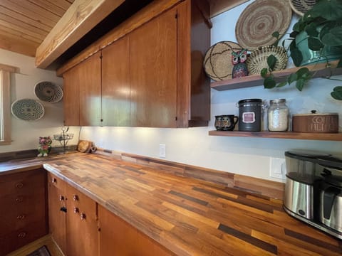Gorgeous walnut butcher block countertops make you feel right in the woods.