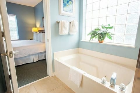 Unwind in a deep soaking tub beside sunlit windows.