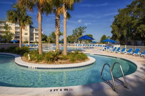 Splash and play in the lagoon-style pool under palms.