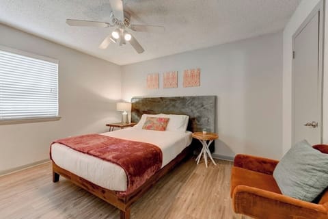 Bright primary bedroom featuring a comfortable bed, soft linens, and a calm, relaxing design.