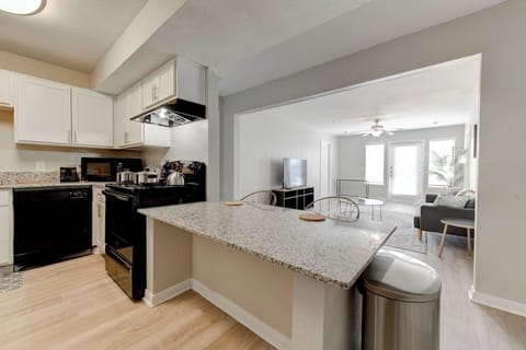 Open-concept layout connecting kitchen, dining & living spaces