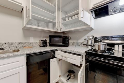 Kitchen prep area w/ stainless appliances & generous storage