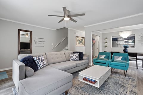 Spacious, comfy living room with 82" Smart TV.