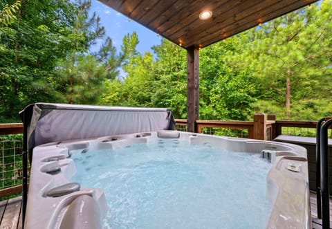 Slip into the hot tub, let the warm bubbles melt away the day, and enjoy the peaceful wooded surroundings from the comfort of the covered deck.