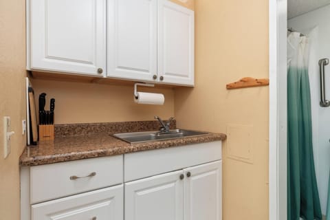 Efficient kitchen setup with basic appliances and utensils — perfect for quick meals during a laid-back stay.