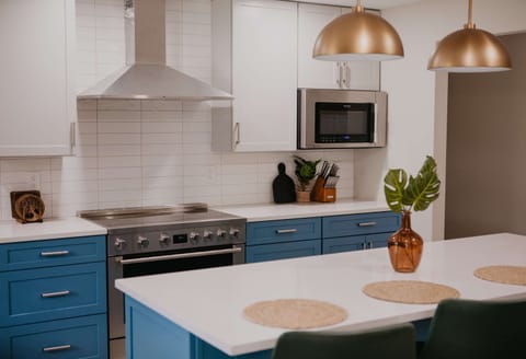 Our fully stocked kitchen features high-end appliances and a large island with high seating — perfect for cooking up feasts, sipping morning coffee, or sharing laughs while you prep meals.

