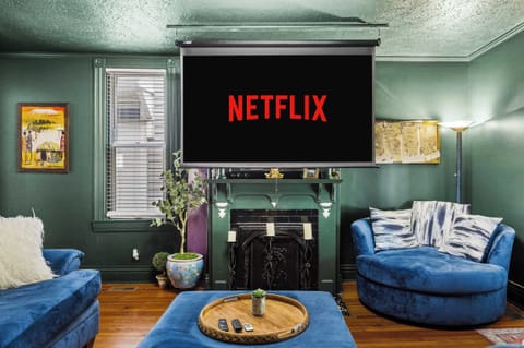 Living Room - Bottom Unit: Lights, camera, relaxation! ✨ Get ready for epic movie nights on our projector TV, all from the comfort of this plush living room.