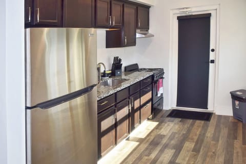 Golden hour spills across open shelving, highlighting artisan ceramics