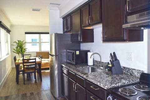 Golden hour spills across open shelving, highlighting artisan ceramics