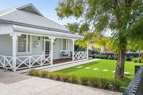 Charming retreat with a wide porch and manicured lawn.