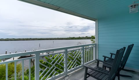Watch boats drift by from shaded balcony comfort outdoors.
