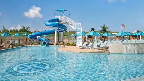 Splash into vacation mode with thrilling waterslide and sun loungers.