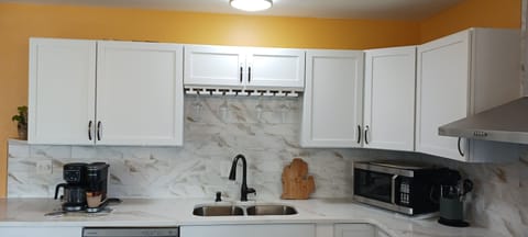 Kitchen sink with spray head and wine glass rack.