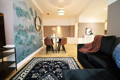 A beautifully styled living space featuring a comfortable sofa, elegant dining area for four,