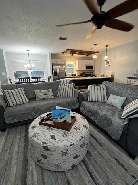Living Room featuring a couch, love seat and ottoman. 