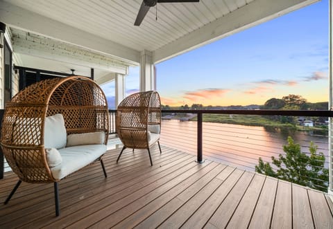 Relax on the spacious balcony with cozy seating and serene lake views.
