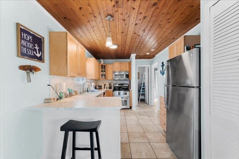 Open kitchen with modern appliances and a breakfast bar for casual meals or morning coffee.