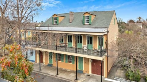 This historic Creole townhouse captures the essence of New Orleans with its wrought-iron balcony, tall shuttered doors, and colorful details that showcase the city’s timeless charm.