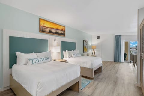 Recharge in a quiet double-bed room with airy coastal tones.