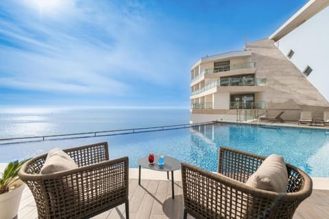 Unwind with cocktails beside the infinity pool and sea views.