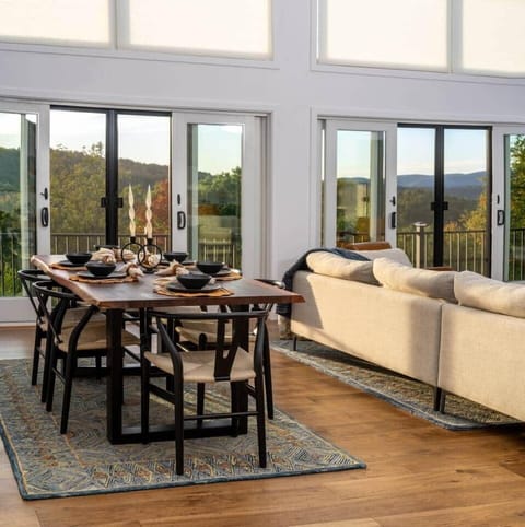 Great room with dining table that seats six large sliding glass doors looking out to the mountain