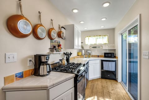 Open kitchen with ample counter space and a cozy table for work or meals.