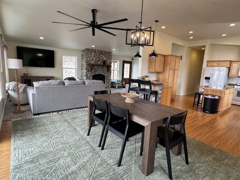 Dining room with seating at the table, bar and kitchen island.