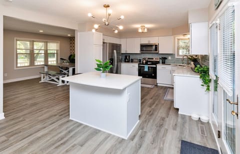 Kitchen w/ island, fridge, stove/oven, microwave, dishwasher and all kitchenware