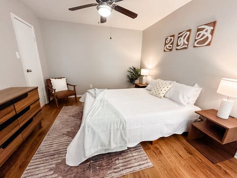 Inviting downstairs bed with soft pillows, perfect for unwinding.