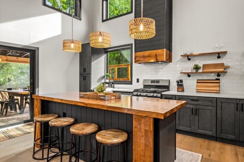 Woven-shade pendants cast warmth and texture over the island.