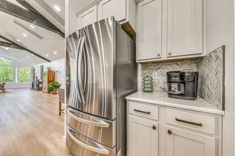 Kitchen | Modern stainless steel refrigerator with coffee station and stylish backsplash