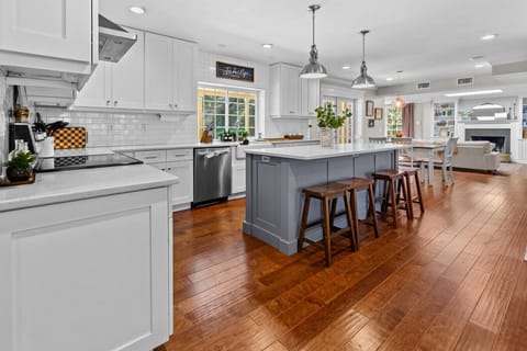 Bright kitchen with view of the pool and lush trees
