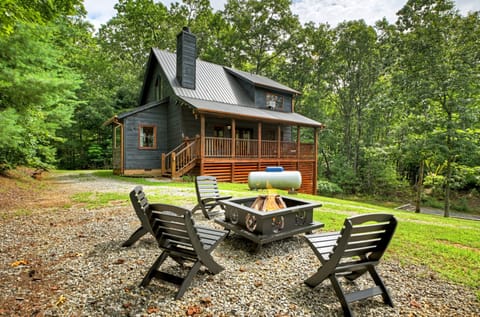 Charming cabin with outdoor firepit area, perfect for evening gatherings.
