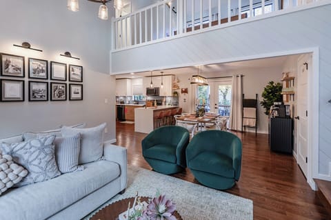 Cozy living space with sofa, fireplace, and tall ceilings.