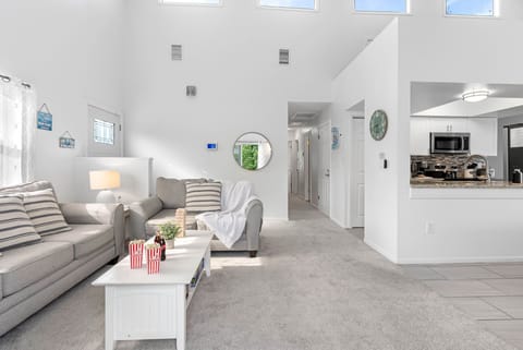 Sunlight fills this open-concept living space, where cozy seating and modern touches create the perfect place to relax with family and friends.